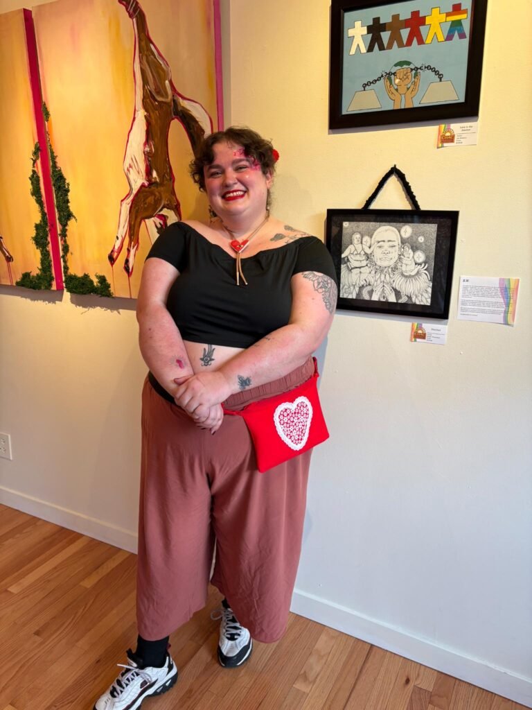 evann standing in front of their art