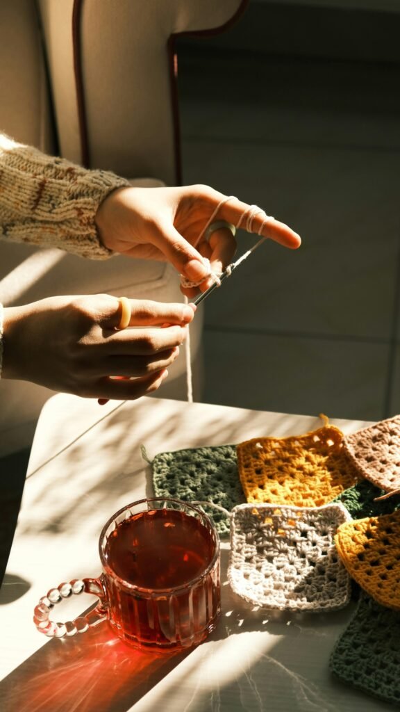 pexels-photo-29889876-29889876 Warm sunlight illuminates knitting and tea, creating a cozy atmosphere.