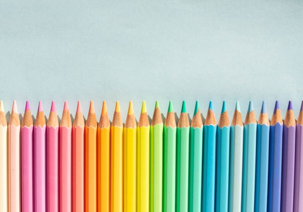 Bright and colorful pencils aligned on a light background, perfect for creative projects.